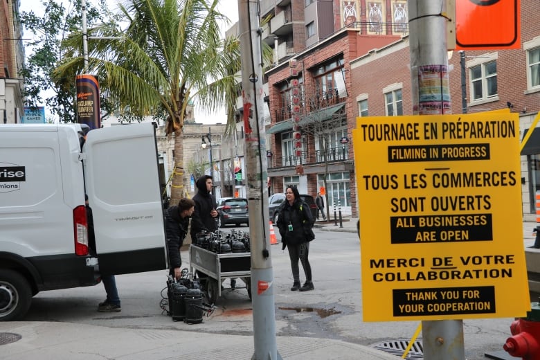 sign, people working in background