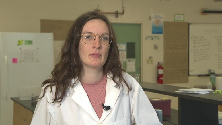 A woman in a white lab coat.