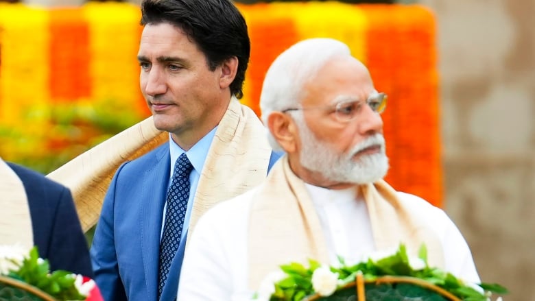 Prime Minister Justin Trudeau, left, walks past India's Prime Minister Narendra Modi as they take part in a wreath-laying ceremony at Raj Ghat, Mahatma Gandhi's cremation site, during the G20 Summit in New Delhi, Sunday, Sept. 10, 2023.