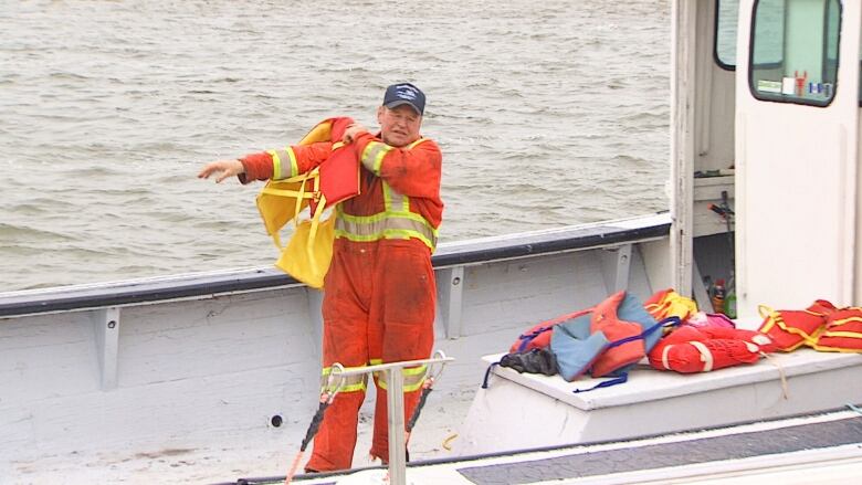 Fisherman putting on life jacket.