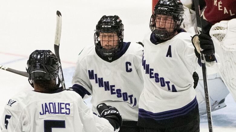 Minnesota PWHL player celebrates a goal against Montreal with teammates during a April 18, 2024 game.