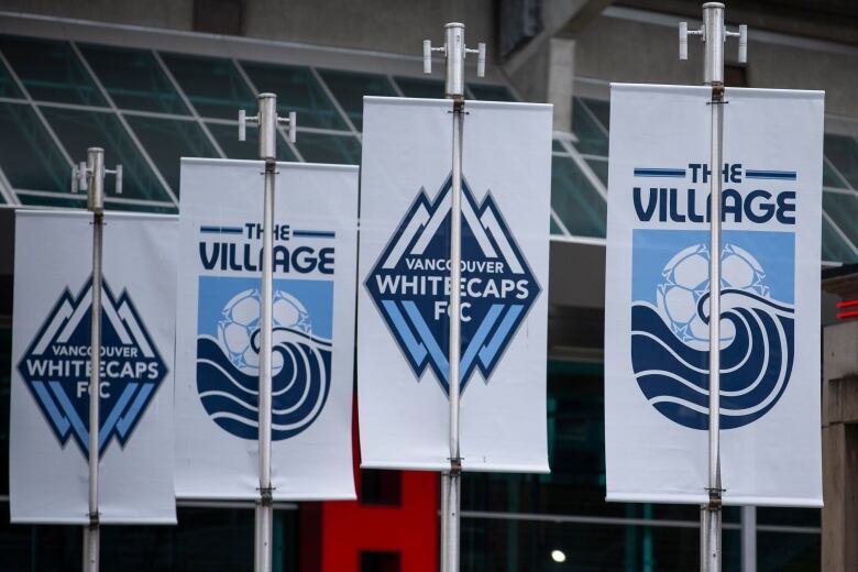 A series of banners with the Vancouver Whitecaps logo and 'The Village'.