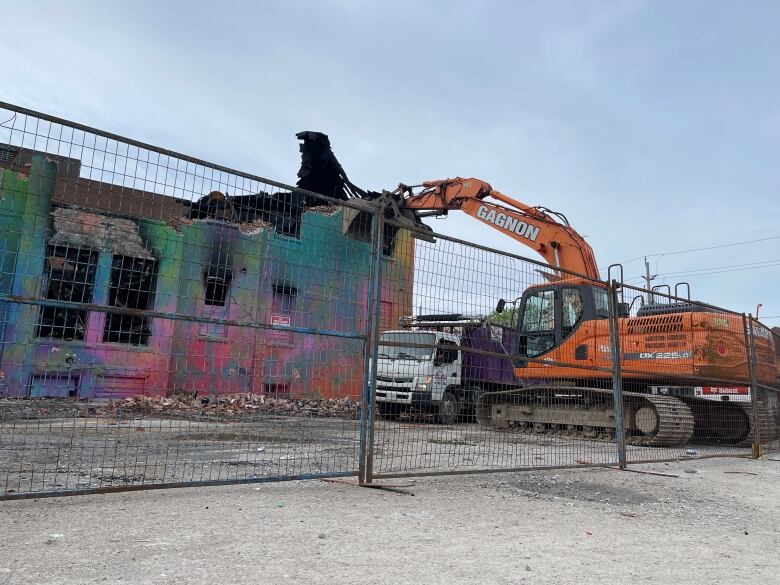 Demolition crews break apart Windsor's 'rainbow house' less than a week after it was destroyed by fire.