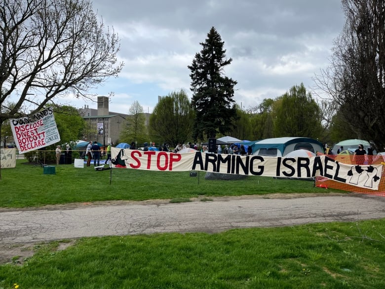 A banner sits in front of tents.