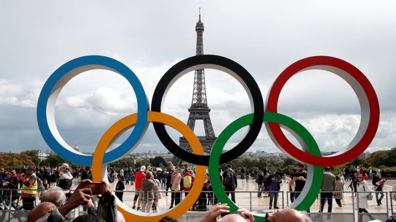 The Olympics rings with the Eiffel Tower in the background.