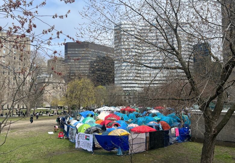 tents of many colour within a fence