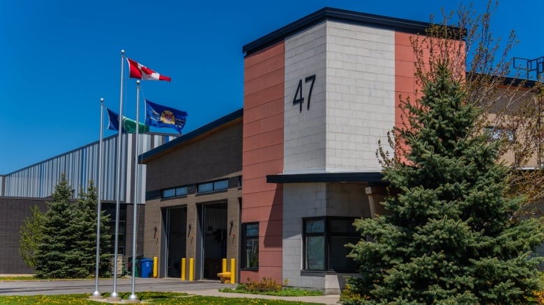 A building with a large number 47 on it and flags out front.