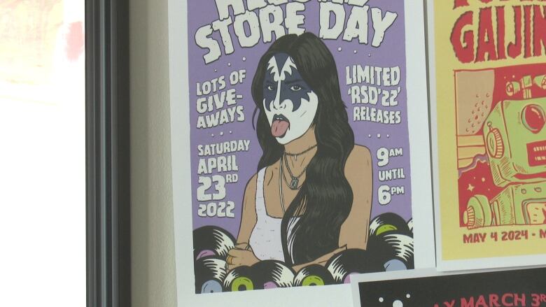 A poster showing a young woman wearing rock and roll makeup.