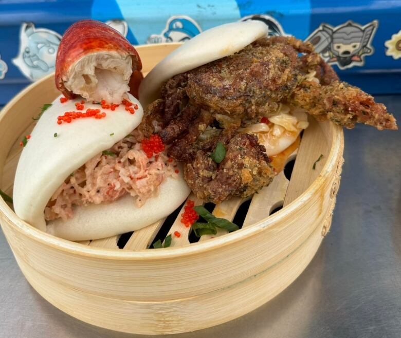 two bao dishes with seafood inside 