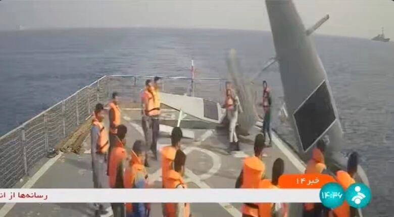 In this image from Iranian state television, Iranian navy sailors throw an American sea drone overboard in the Red Sea on Thursday, Sept. 1, 2022.