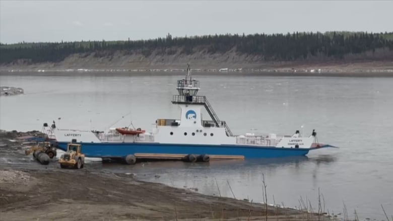 A boat along the shore of a river.