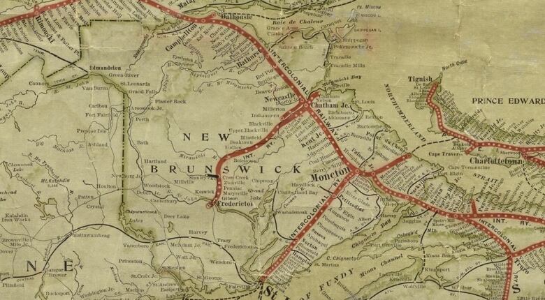 A yellowed map of New Brunswick with a few red lines through it with white dots next to community names.