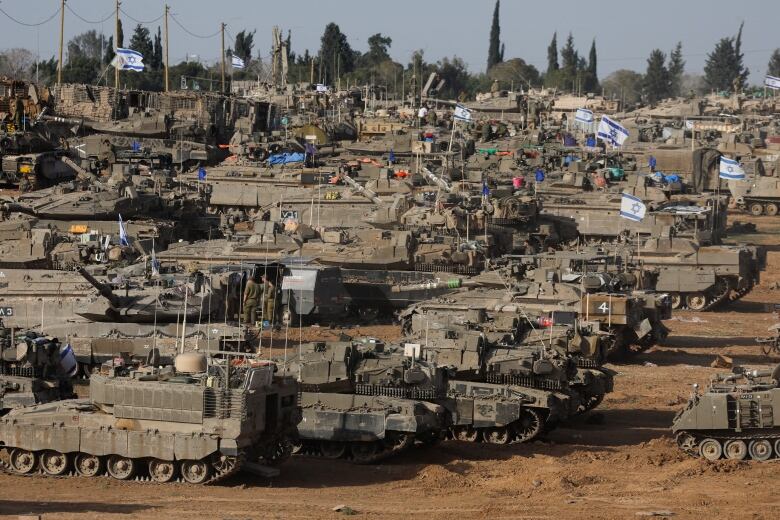 A group of Israeli military vehicles are seen near the country's border with Gaza, in southern Israel.