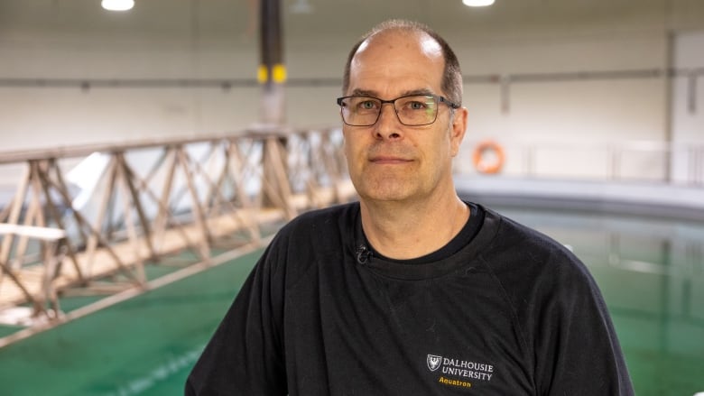 a man poses for a portrait above a pool 