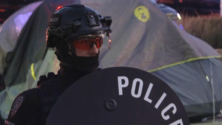 A police officer in riot gear.