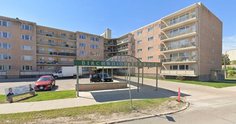 A large apartment building is seen from the street