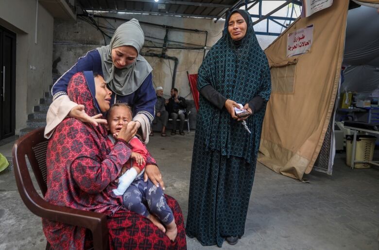 Palestinians mourn their relatives killed in the Israeli bombardment of the Gaza Strip, at a hospital in Rafah, Gaza, Friday, May 10, 2024.