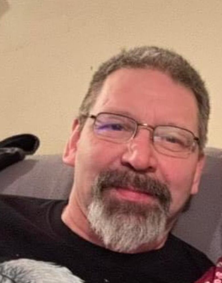 A man with glasses and a beard seen in a close up shot 