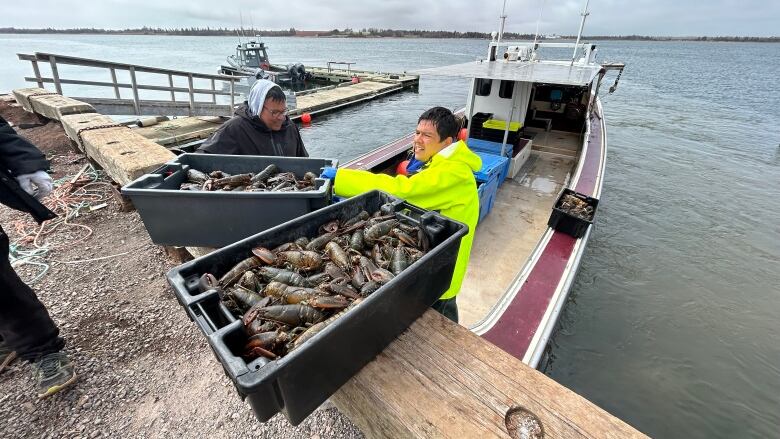 A boat at Lennox Island First Nation unloads lobster catch. 