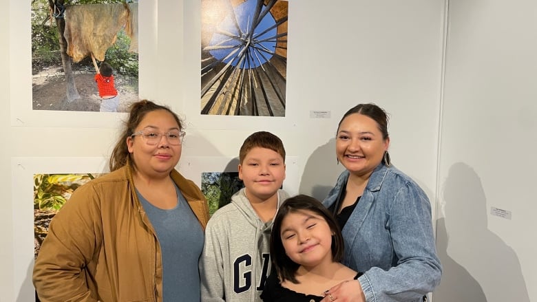 A family posing in front of a photography from the inside of a teepee. 