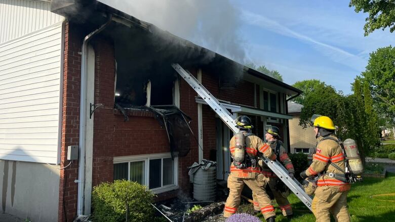 London firefighters work to extinguish a fire that broke out Tuesday morning on Nairn Avenue in east London. 