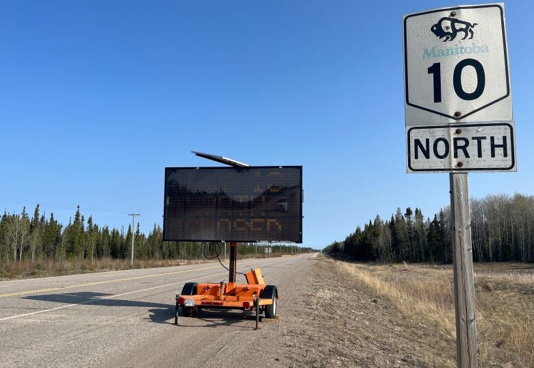 A sign on a highway says the road is closed