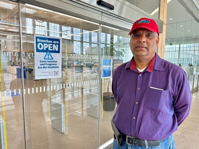 man stands at library entrance