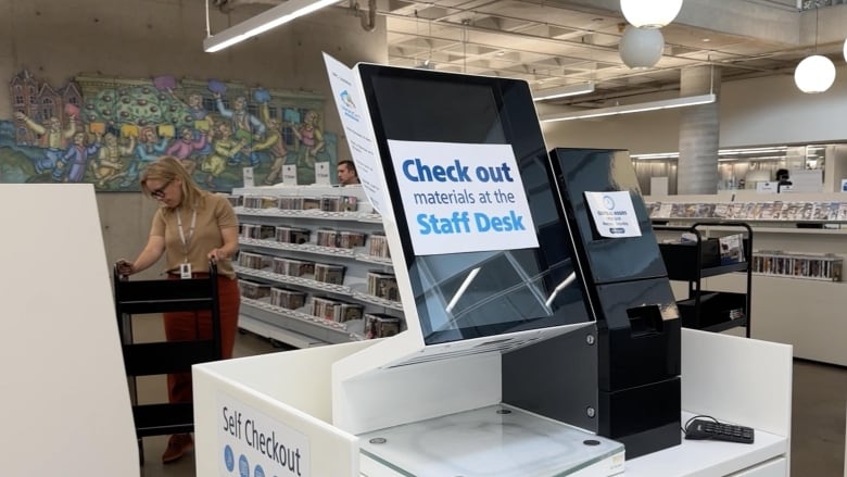 kiosk in library with sign saying it's not working