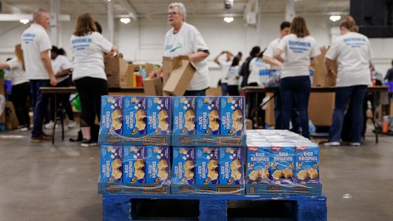 Volunteers help pack healthy food for children in need during a Food Banks Canada packing drive at the International Centre in Mississauga, Ont., on May 15, 2024.