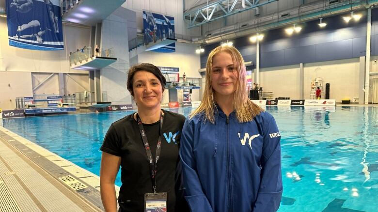 A teenager stands with her coach