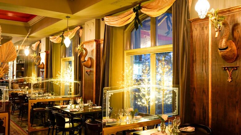 An interior photo of a restaurant with tables set. 