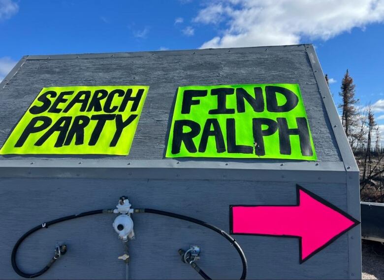 Two signs that read 'search party' and 'find Ralph' 