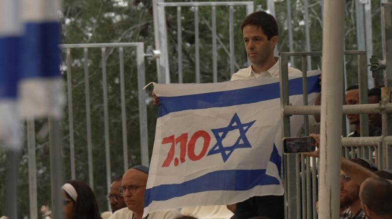 Protestor Nir Galon held a silent vigil throughout Benjamin Netanyahu's speach on Israel's Memorial Day.  He told CBC News the date of the October 7th attacks,  written in red were meant to show that Netanyahu has failed the country.