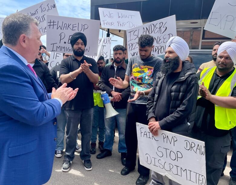 Dennis King speaks with people on a protest line.