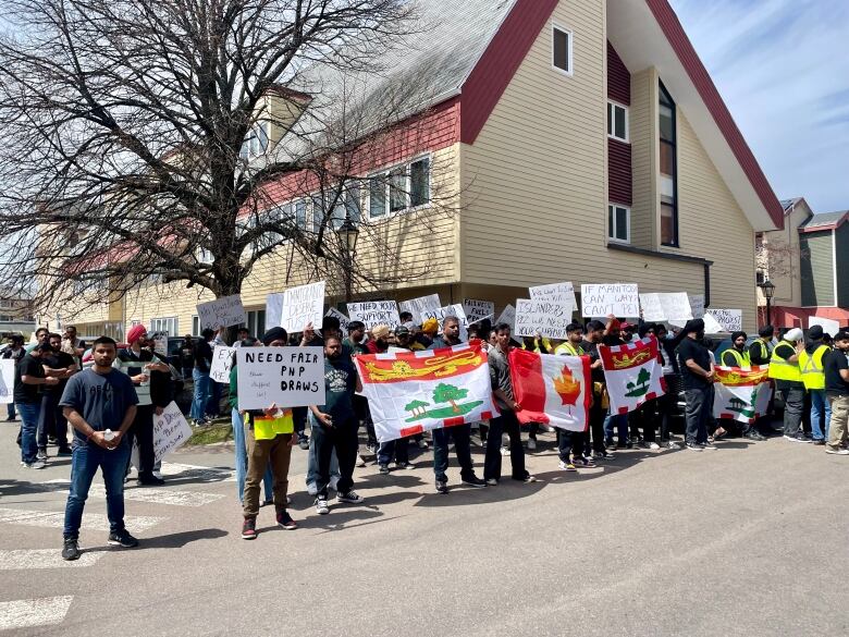 A group of people holding signs and flags.