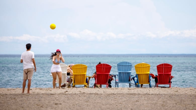 People and chairs on a beach.