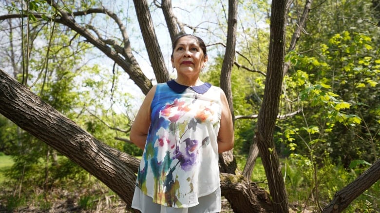 woman in front of tree