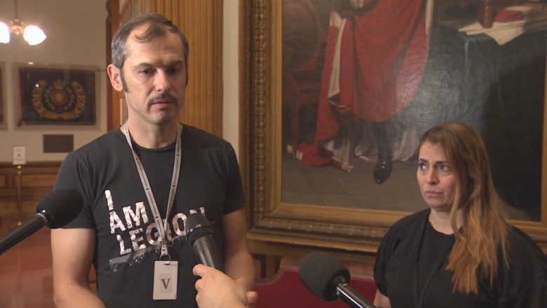 Two people pictured in front of microphones.