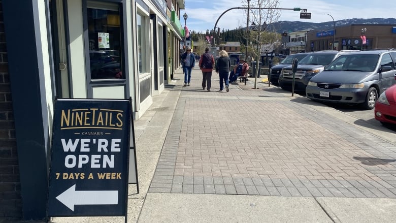 An open sign on a busy city street.