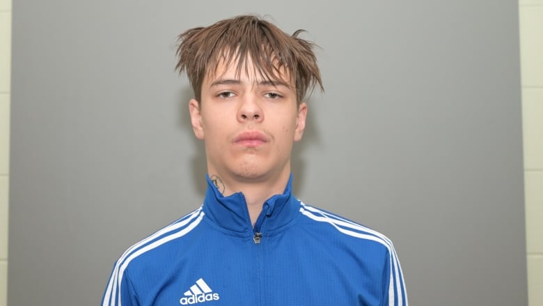 Young man wearing blue Adidas jacket