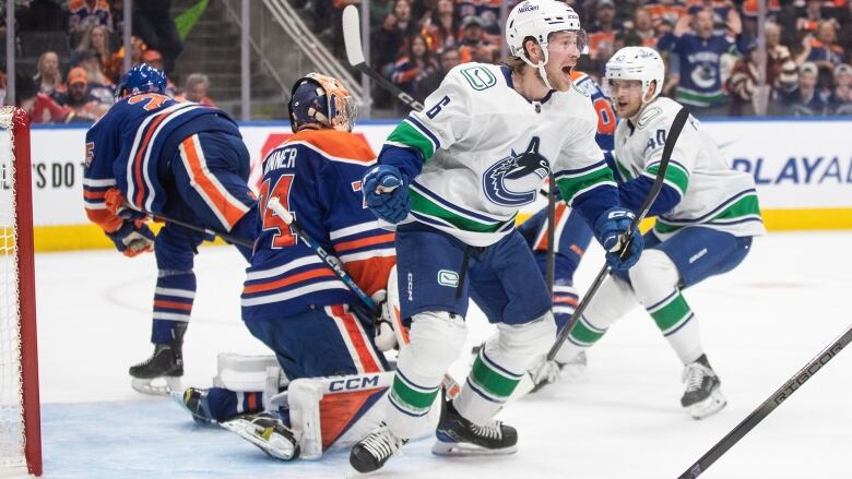 Ice hockey players battle it out in the ice rink trying to score