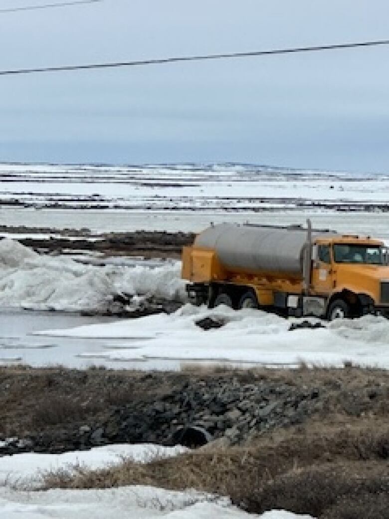 Water truck by an Aupaluk lake