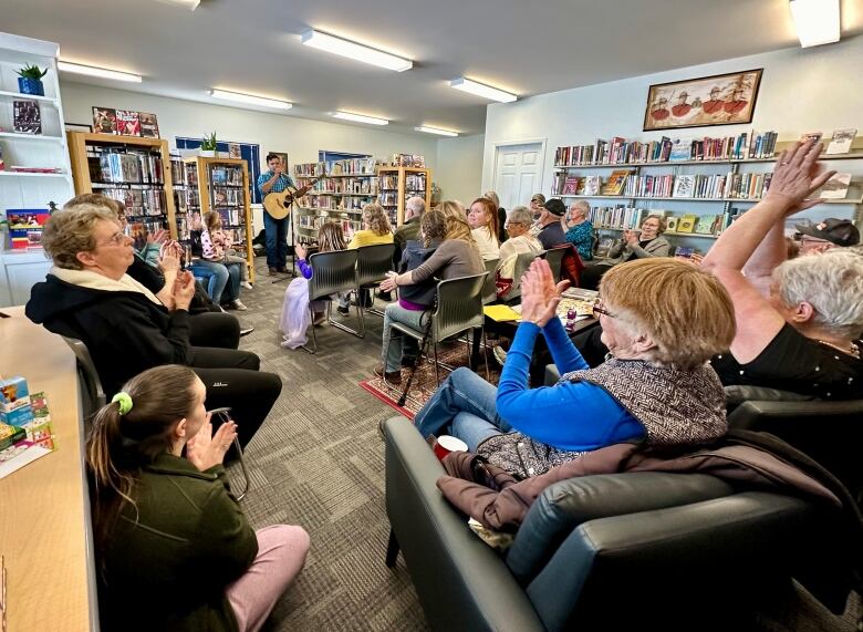 Musician Edward Pimm entertaining the Mayerthrope crowd at the Mayerthrope Public Library