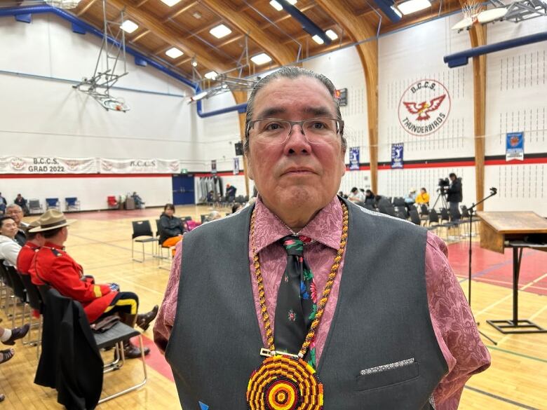 Randy Constant, the director of education at the East Central First Nations Education Partnership, stands in a school gym.