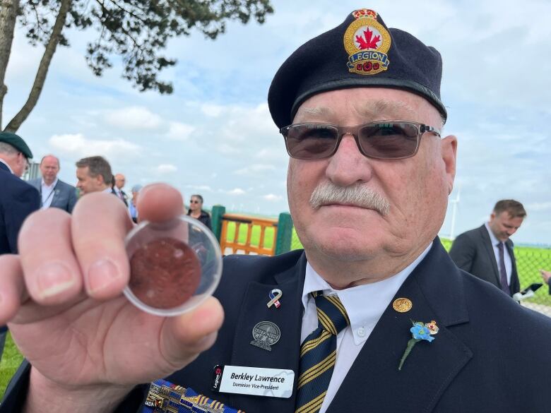 berkley lawrence, a legionnaire, holds an identity disc once worn by his grandfather during service in the First World War.