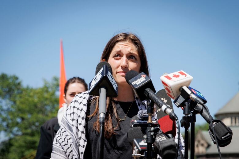 Fourth-year undergrad and encampment spokesperson Erin Mackey speaks to reporters in a pro-Palestinian encampment on the main campus of the University of Toronto on May 24, 2024.