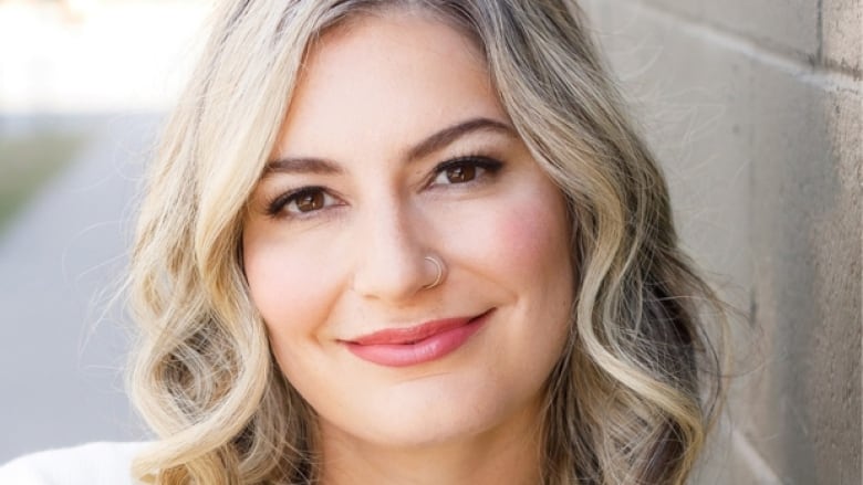 Portrait of an Iranian Canadian woman with wavy blonde hair.