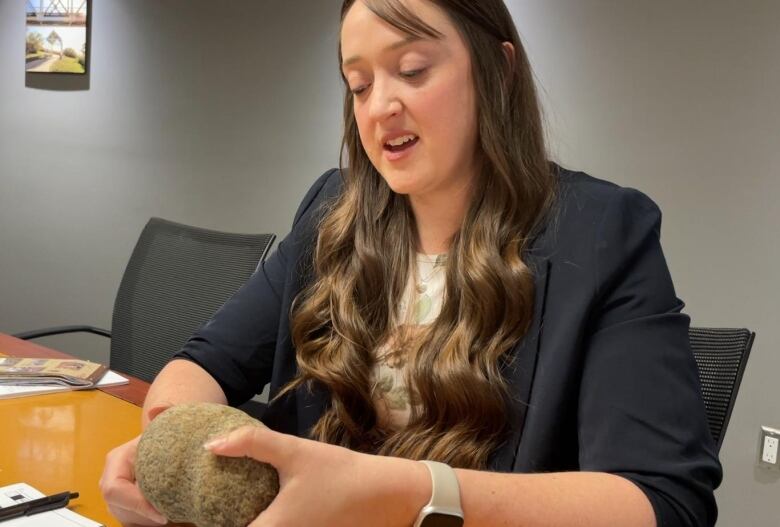 long haired woman with stone