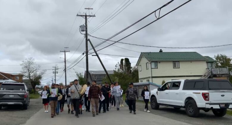 A screen grab from a video posted to Heiltsuk Tribal Council's Facebook page shows community members marching to the RCMP detachment in Bella Bella, B.C.