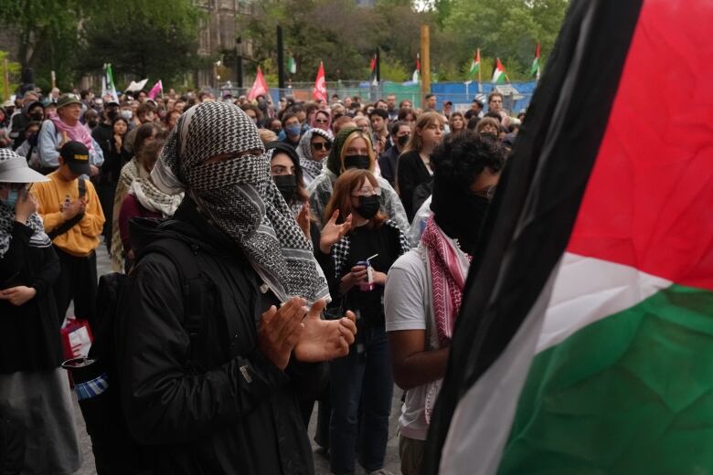 A crowd of supporters rally outside Convocation Hall at UofT, near the pro-Palestinian encampment at the school's downtown campus.